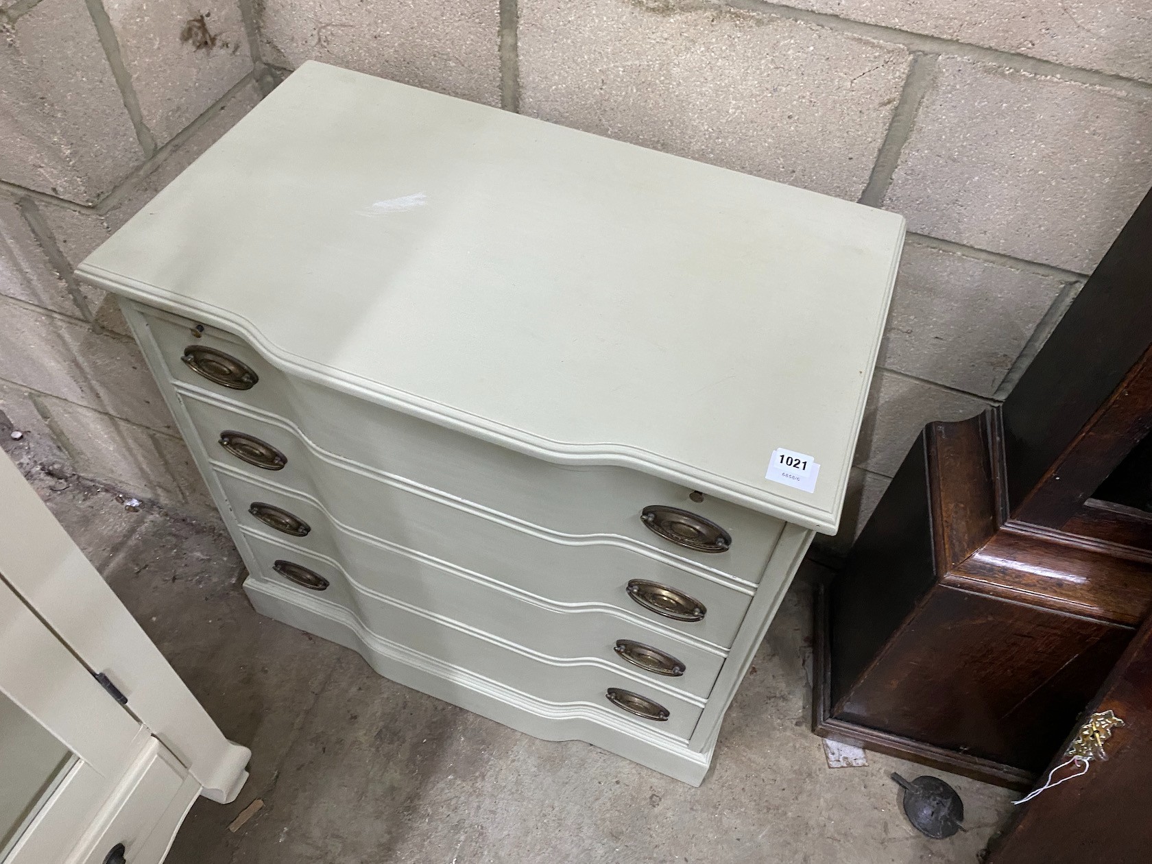 An eau de nil painted chest with brushing slide and four drawers, width 76cm